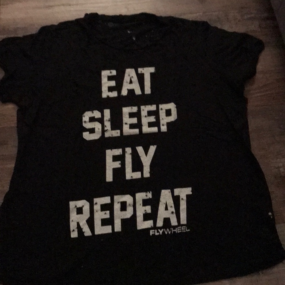 Flywheel tee shirt with hole details on it